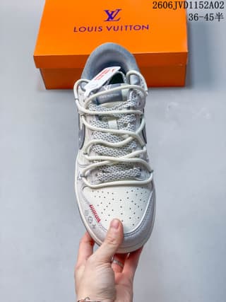 Top view of the sneaker showing white laces, a perforated toe box, patterned side panels, and gray trim.