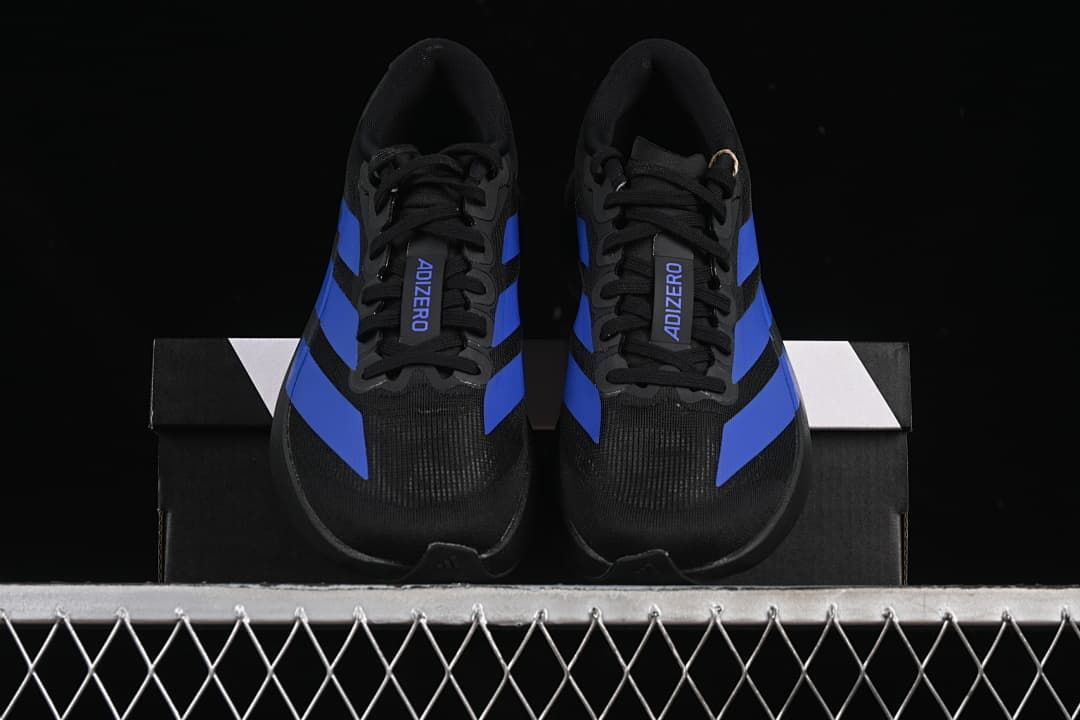 Front view of the pair showing black uppers and blue stripes.