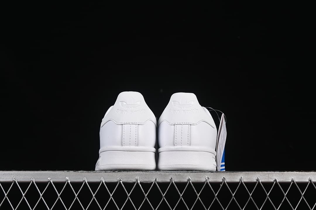 Rear view of both white sneakers