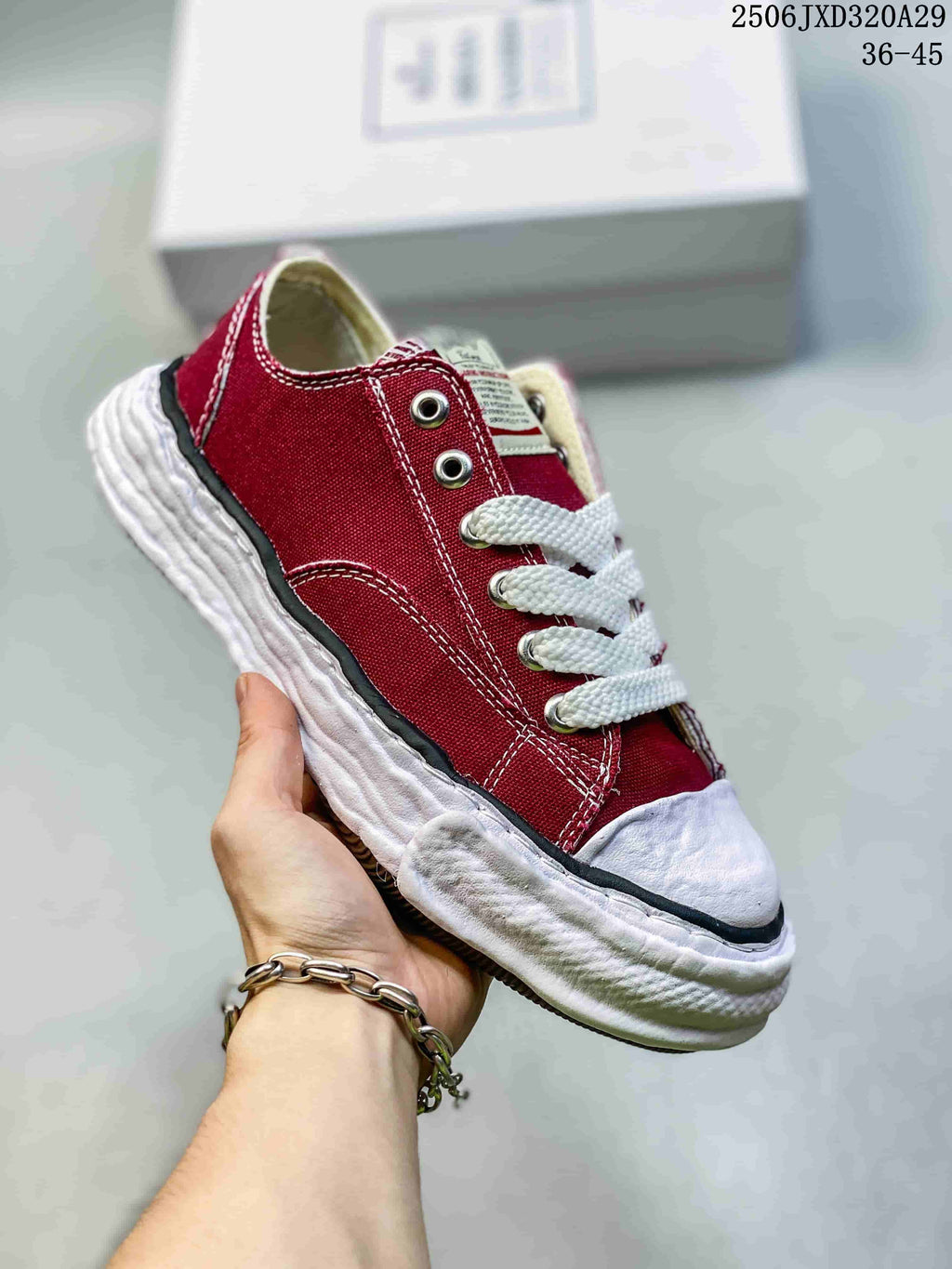 Angled view of the burgundy sneaker showing its lace-up front and textured sole
