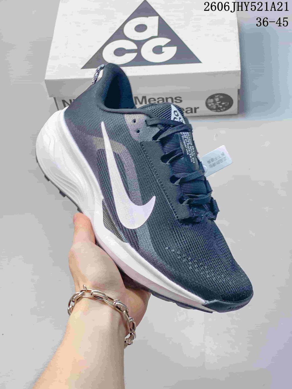 Angled side view of a dark gray Nike ACG Etcon 10 shoe with white accents