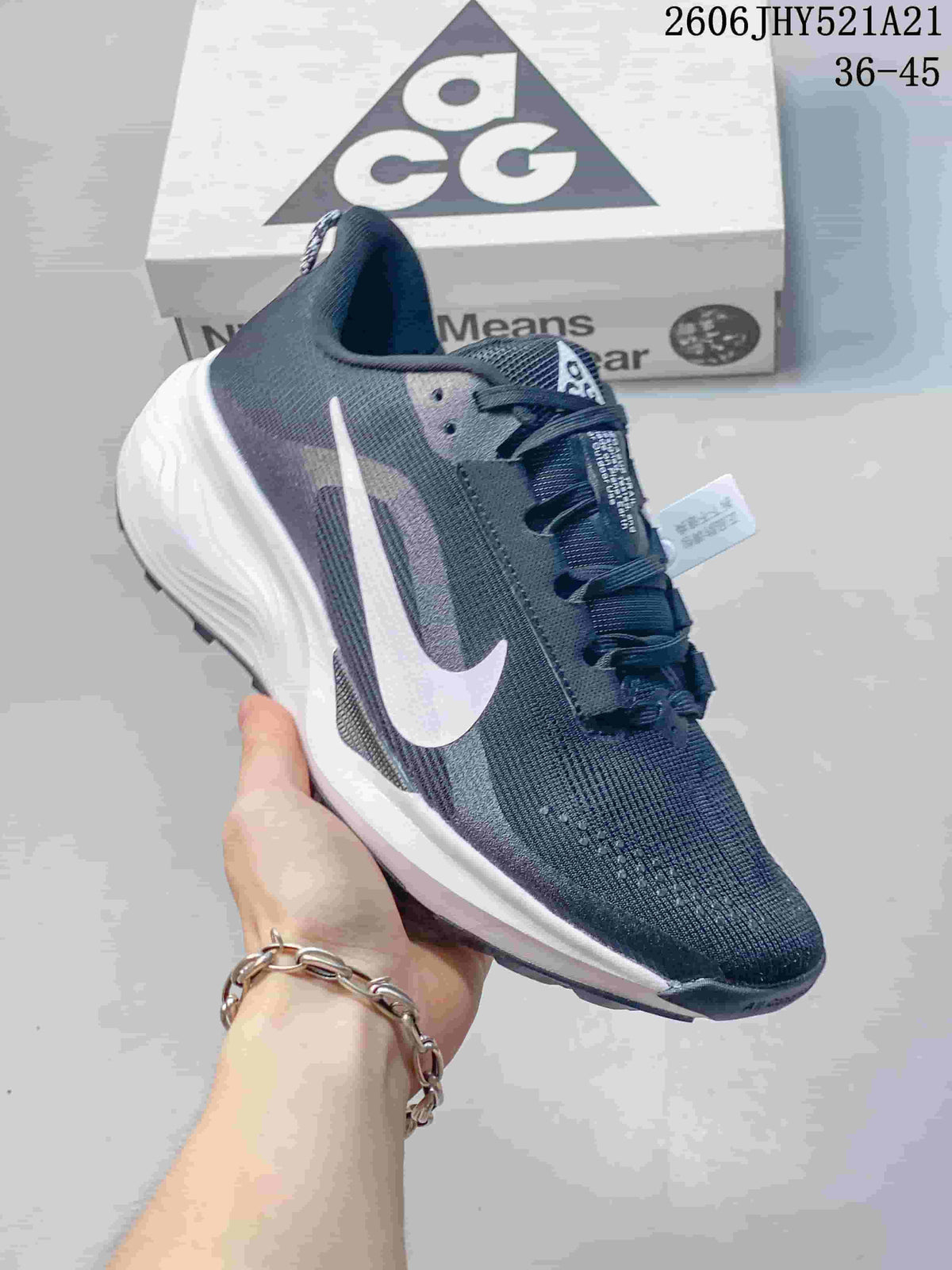 Angled side view of a dark gray Nike ACG Etcon 10 shoe with white accents
