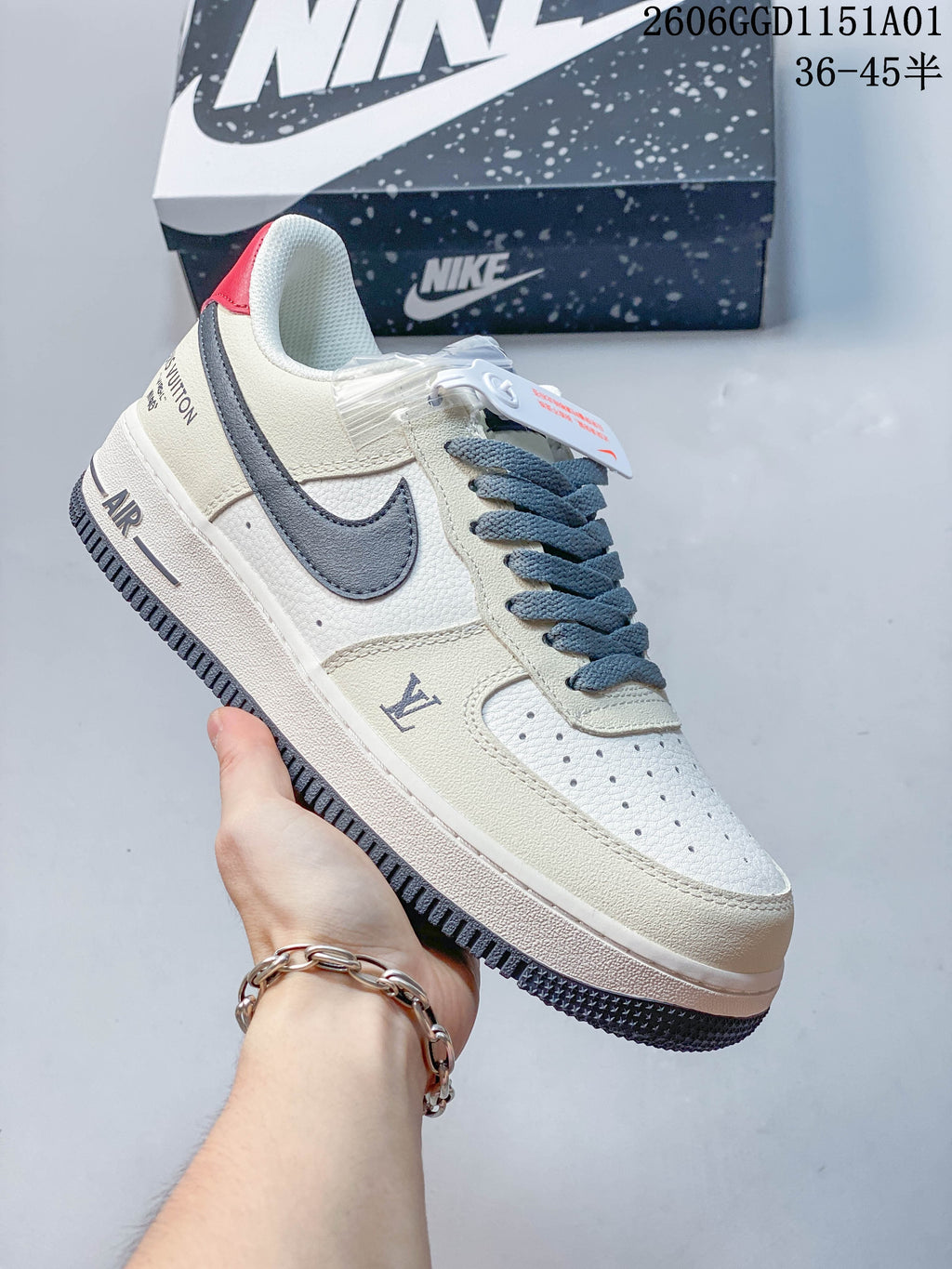 Angled side view of an off-white Nike Air Force 1 '07 LV8 sneaker with gray-blue accents and a red heel detail.