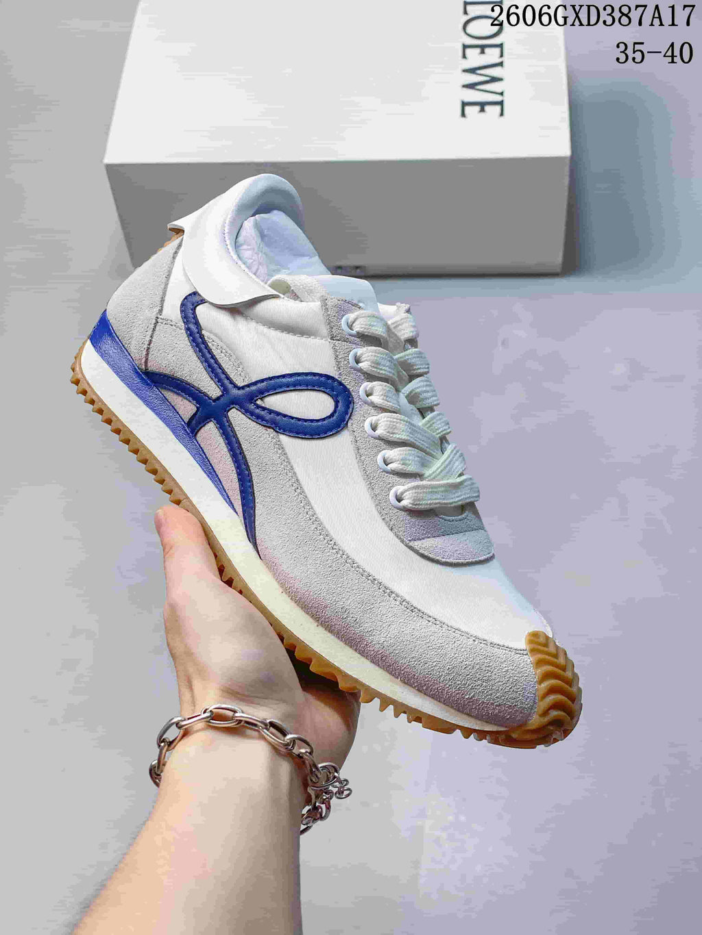 Angled side view of the sneaker with blue detailing and gum tread