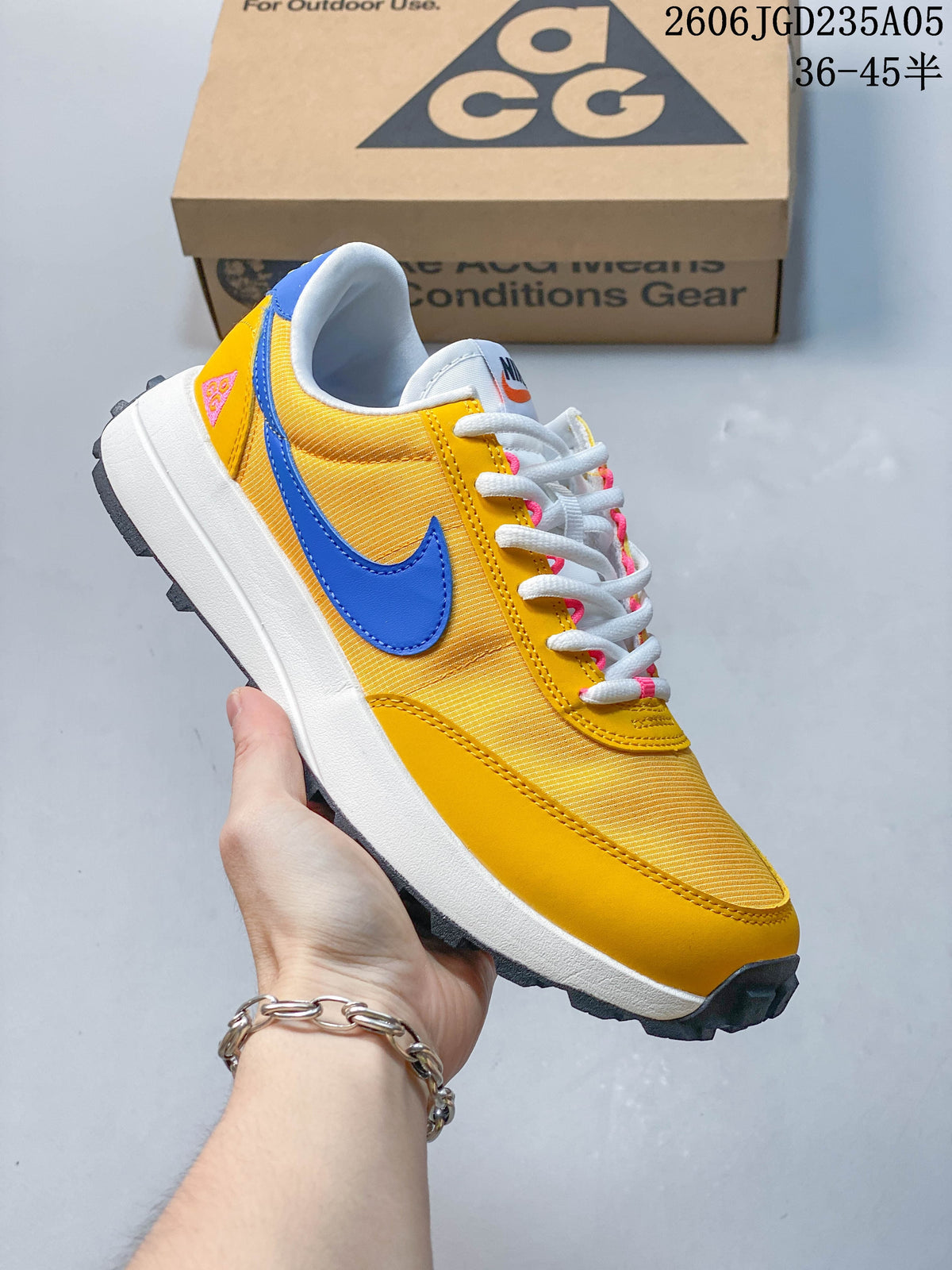 Angled side view of the yellow and blue shoe with its rugged outsole