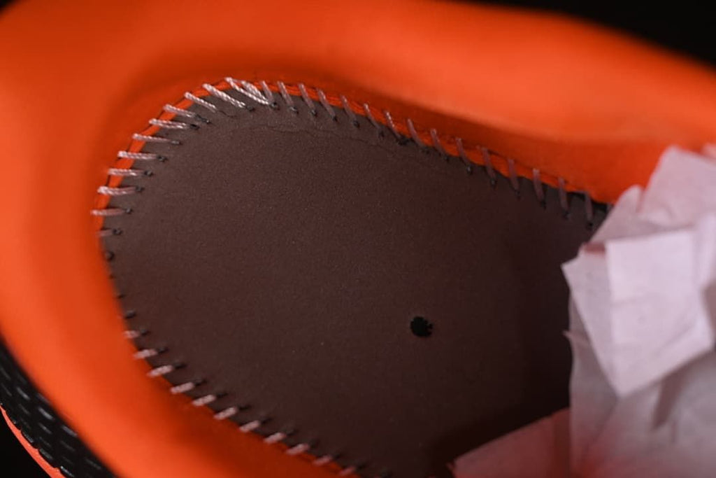 Close-up of the orange padded collar and inner stitching.