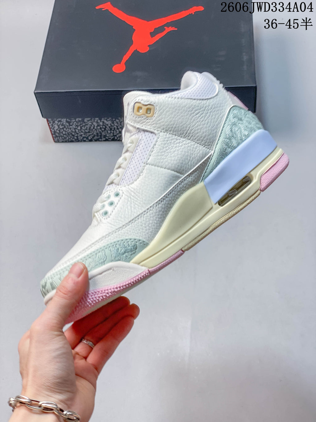 Side profile highlighting the pale mint overlays, cream midsole and visible heel unit