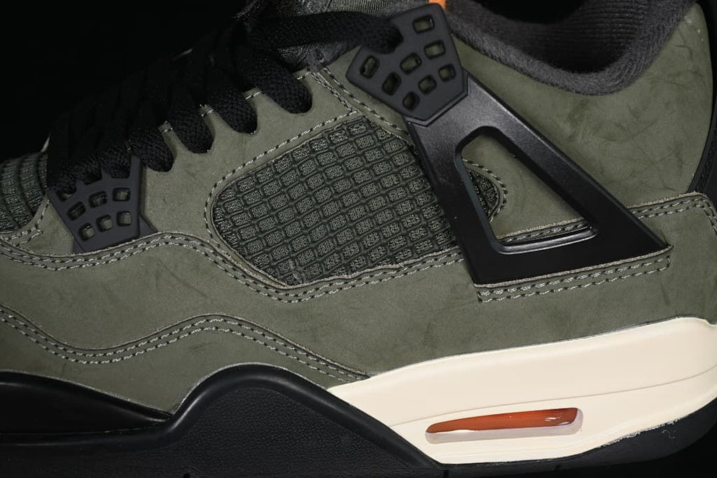 Close-up of the black side cage, mesh panel, and olive upper
