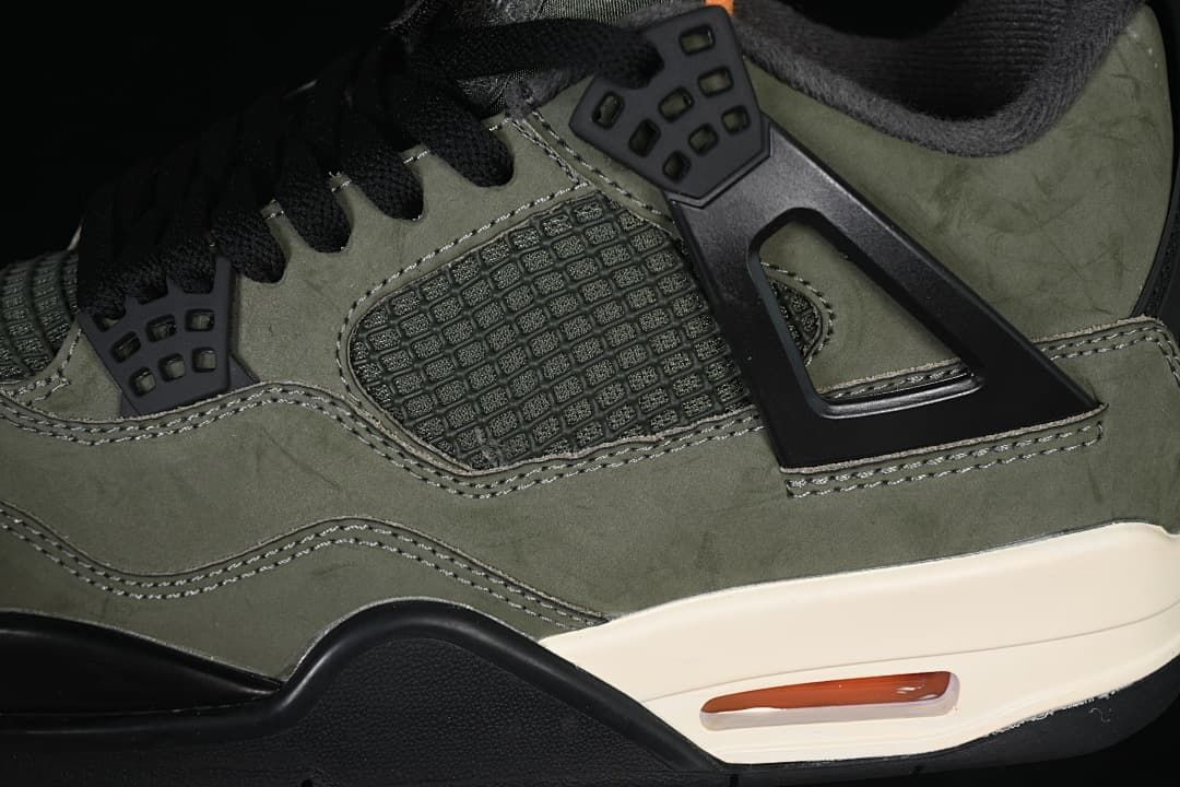 Close-up of the black side cage, mesh panel, and olive upper