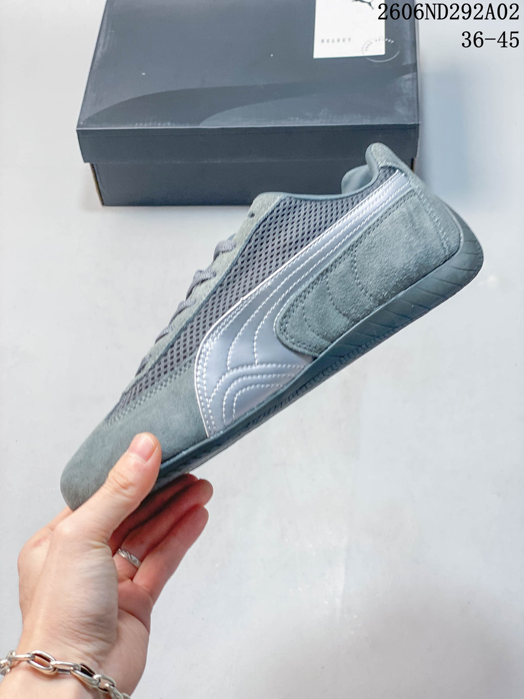 Side profile of a gray Puma Speedcat sneaker with contrasting formstrip detail