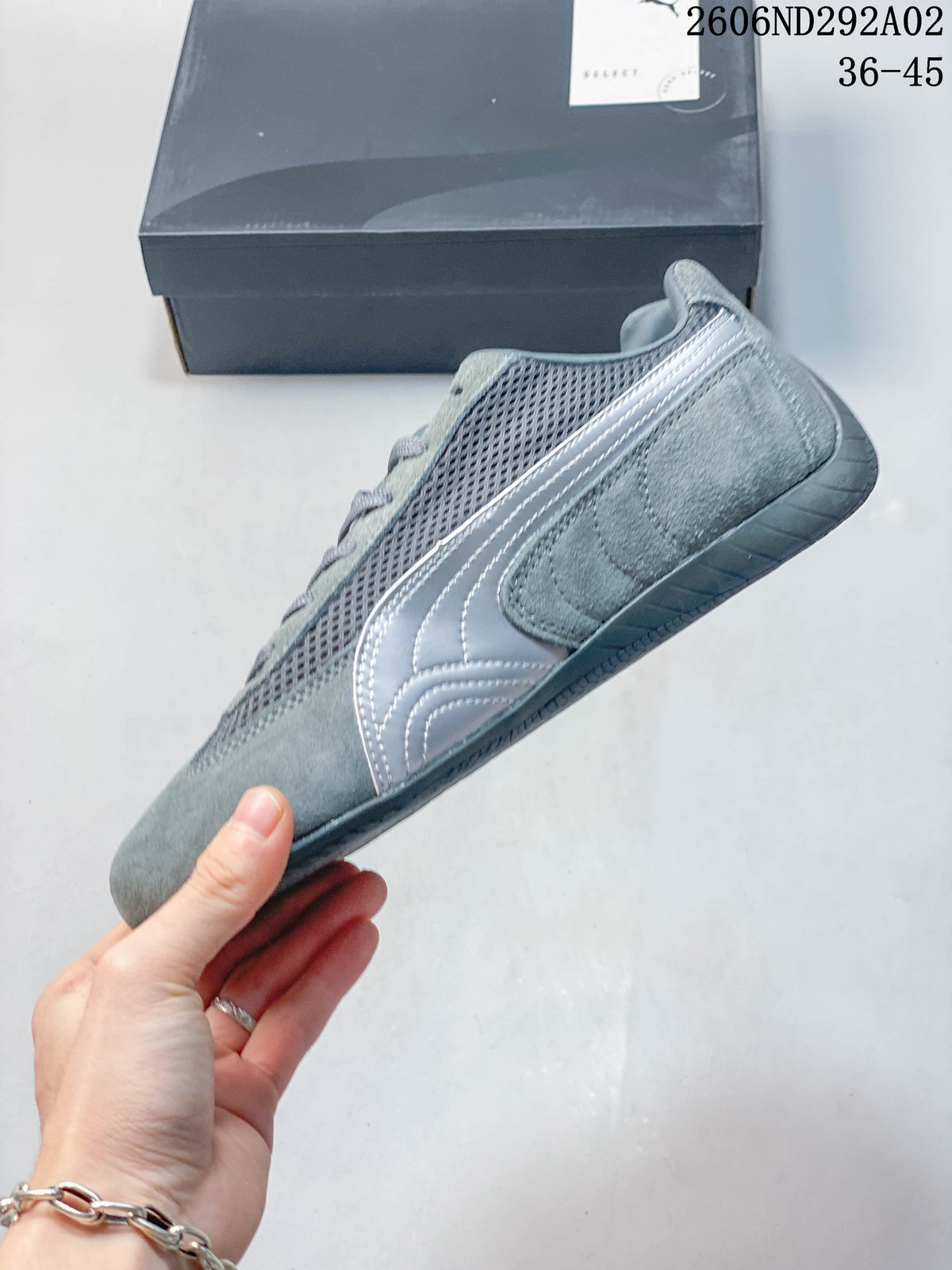 Side profile of a gray Puma Speedcat sneaker with contrasting formstrip detail