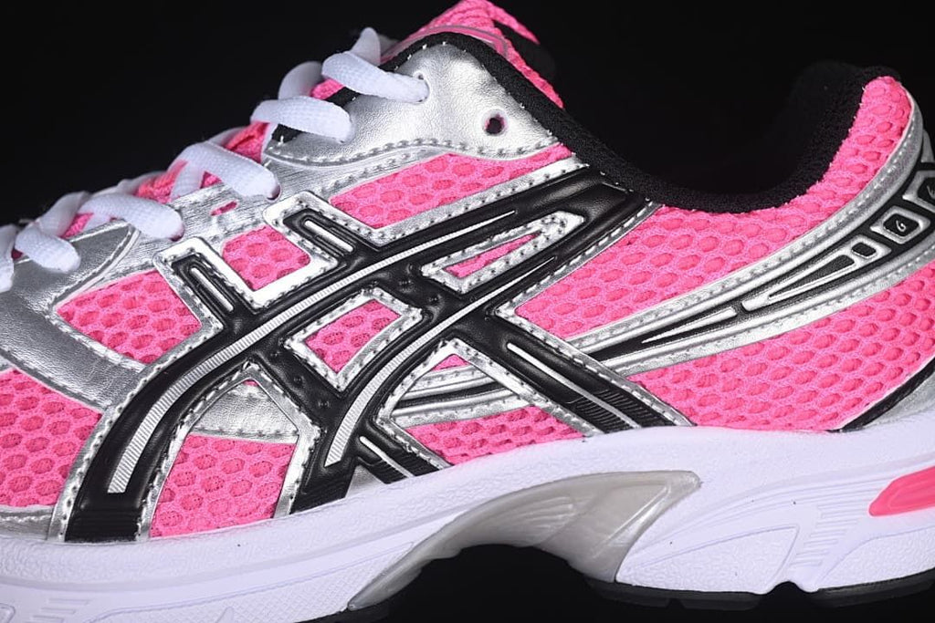 Close-up of the sneaker side with black ASICS-style overlays and silver panels.