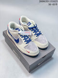 Pair of cream, gray, and blue low-top sneakers with bear graphics, shown on a box.