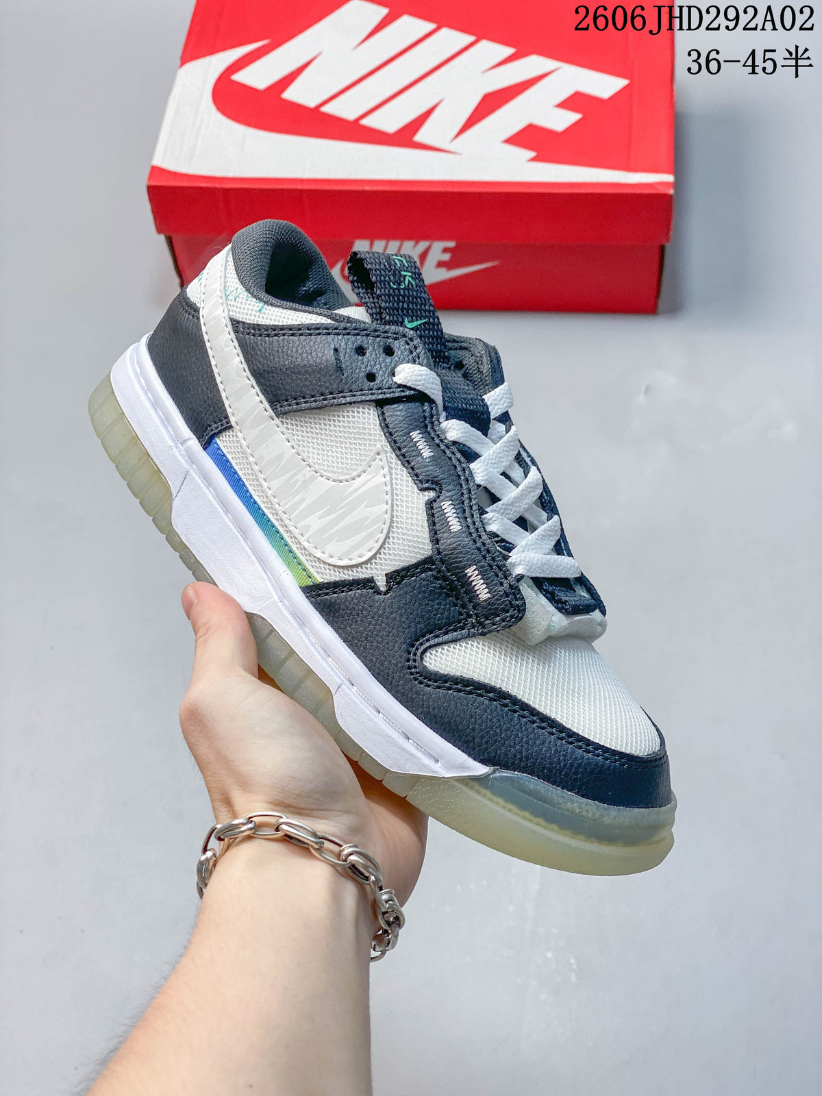Navy and white Nike SB Dunk low-top sneaker with a contrasting outsole, shown beside a Nike shoe box.