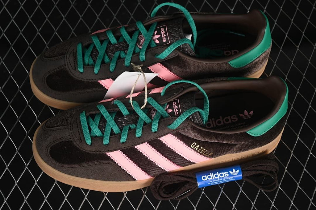 Pair of brown, pink, and teal Gazelle Indoor sneakers displayed with an extra set of dark laces.
