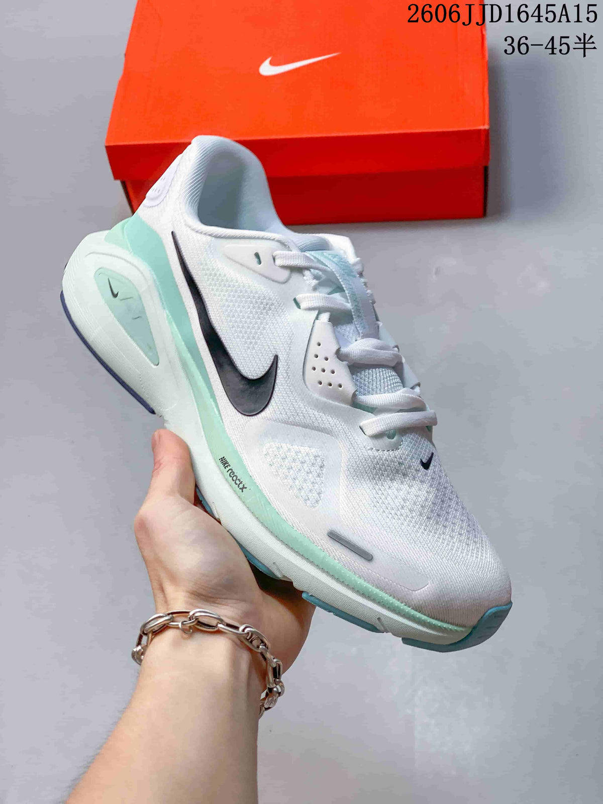 White Nike Air Structure 26 running shoe with pale mint accents and a dark Swoosh.
