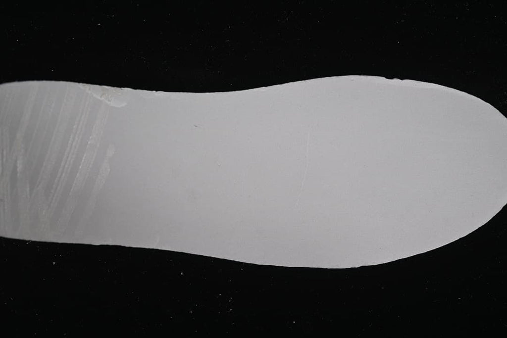 Plain light-colored shoe sole shown by itself.