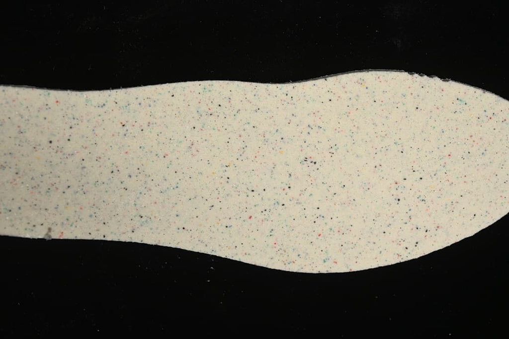 Speckled light-colored shoe insole shown separately