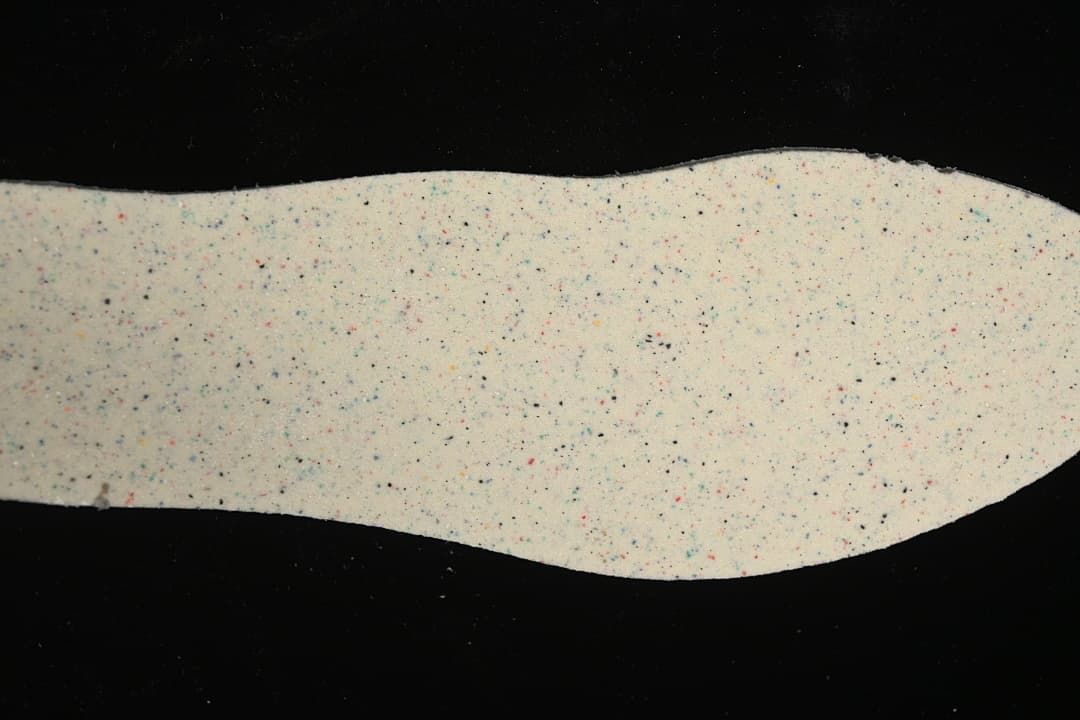 Speckled light-colored shoe insole shown separately