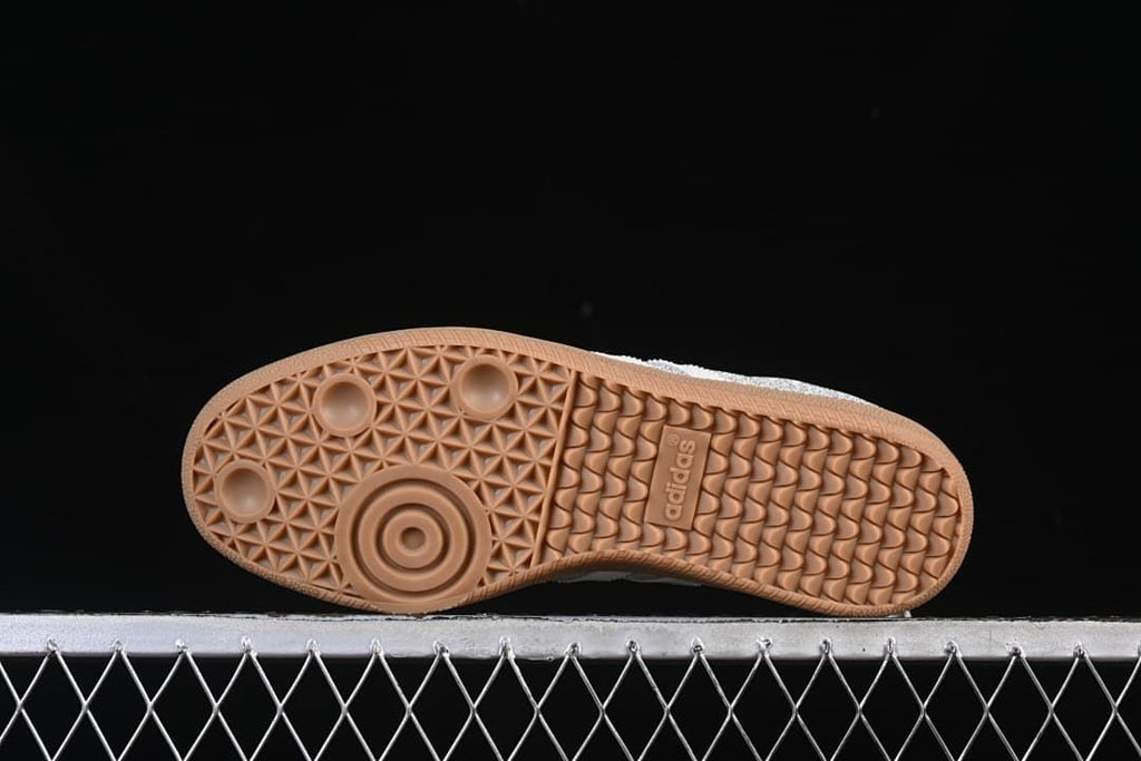 Gum-colored outsole with textured traction pattern and adidas branding.