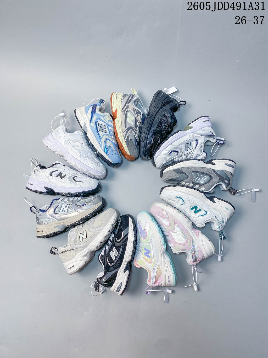 A group of kids' New Balance sneakers in assorted colors arranged in a circle.