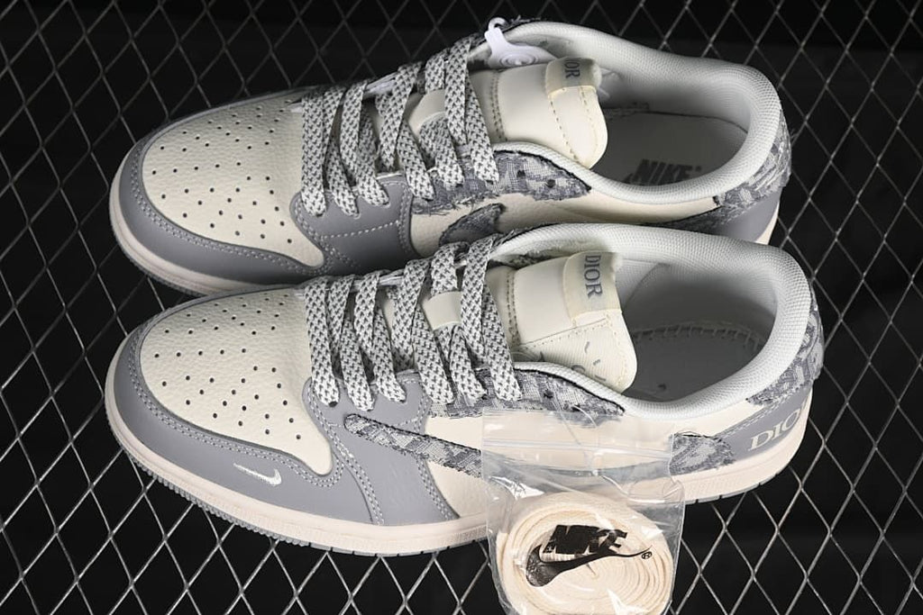 Pair of gray and white low-top sneakers shown from above, with patterned laces and a spare lace set