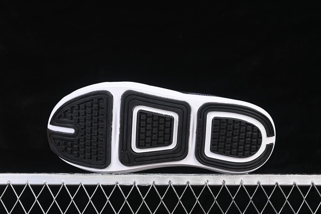 Underside view showing the black-and-white patterned outsoles.