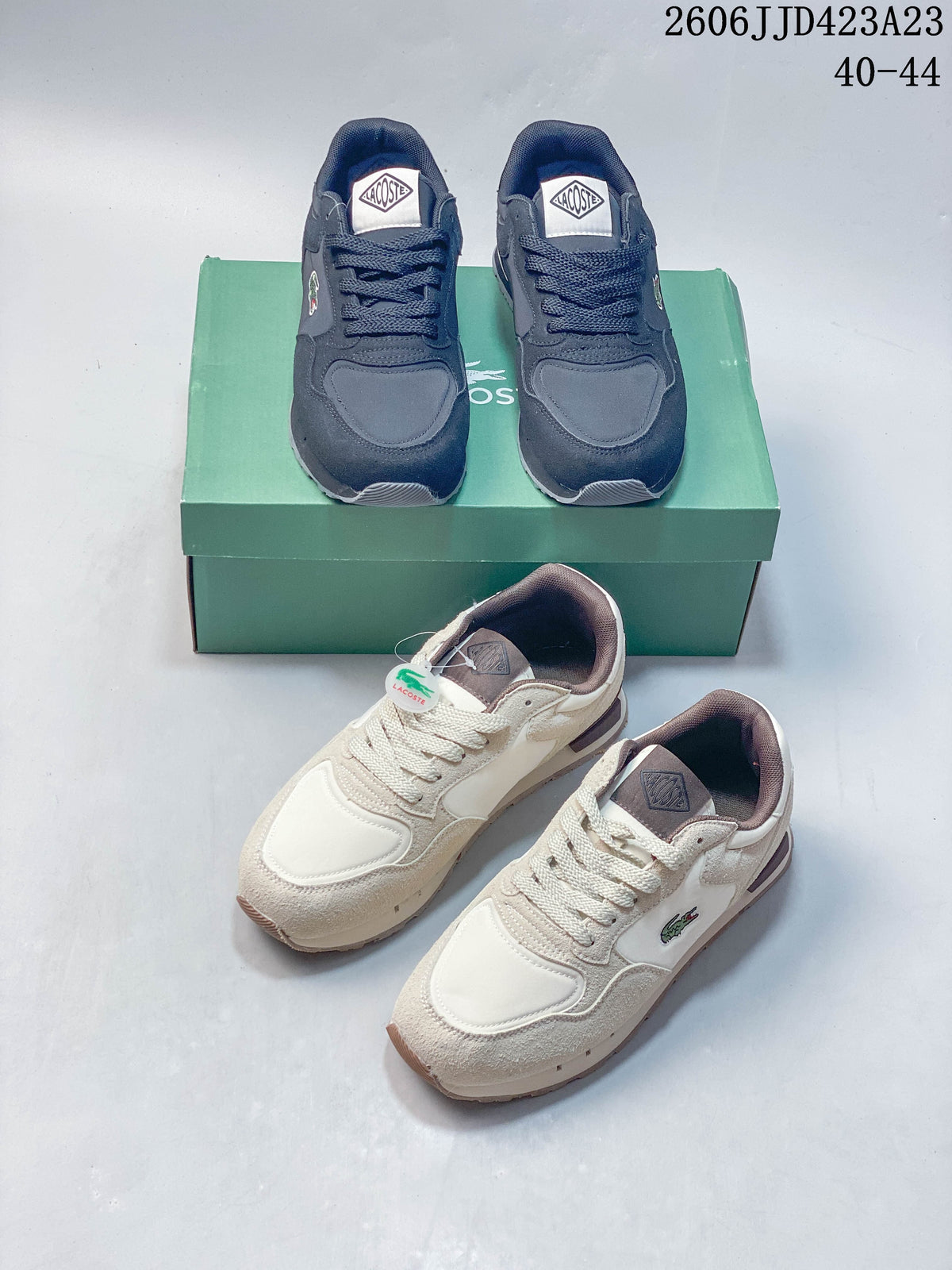 Navy and cream low-top sneakers shown together with a green shoe box