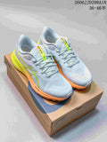 Pair of pale blue-gray ASICS running shoes with lime and orange accents, shown on a shoe box