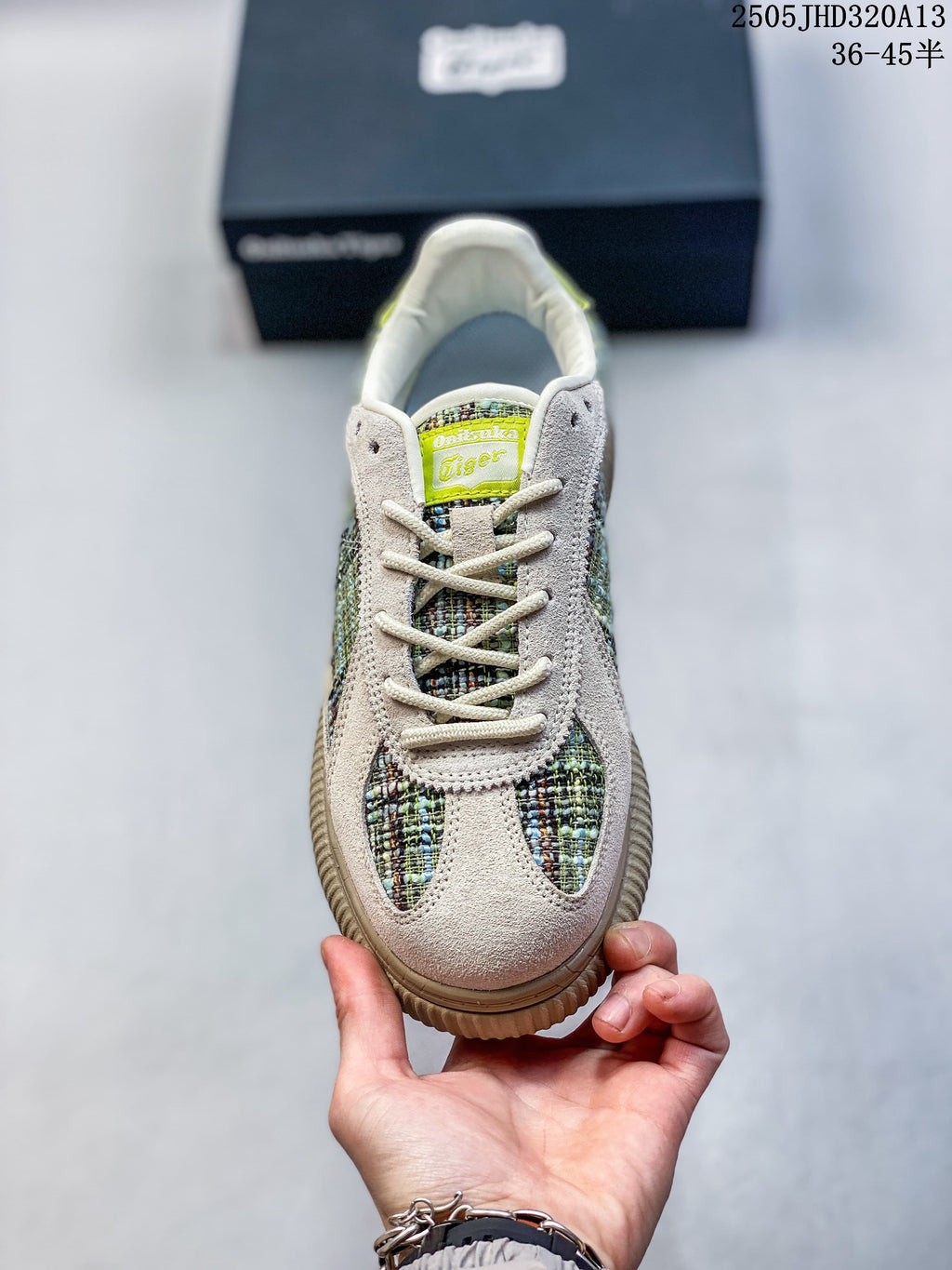 Front view of a lace-up low-top sneaker with multicolored panels and lime-green tongue detail