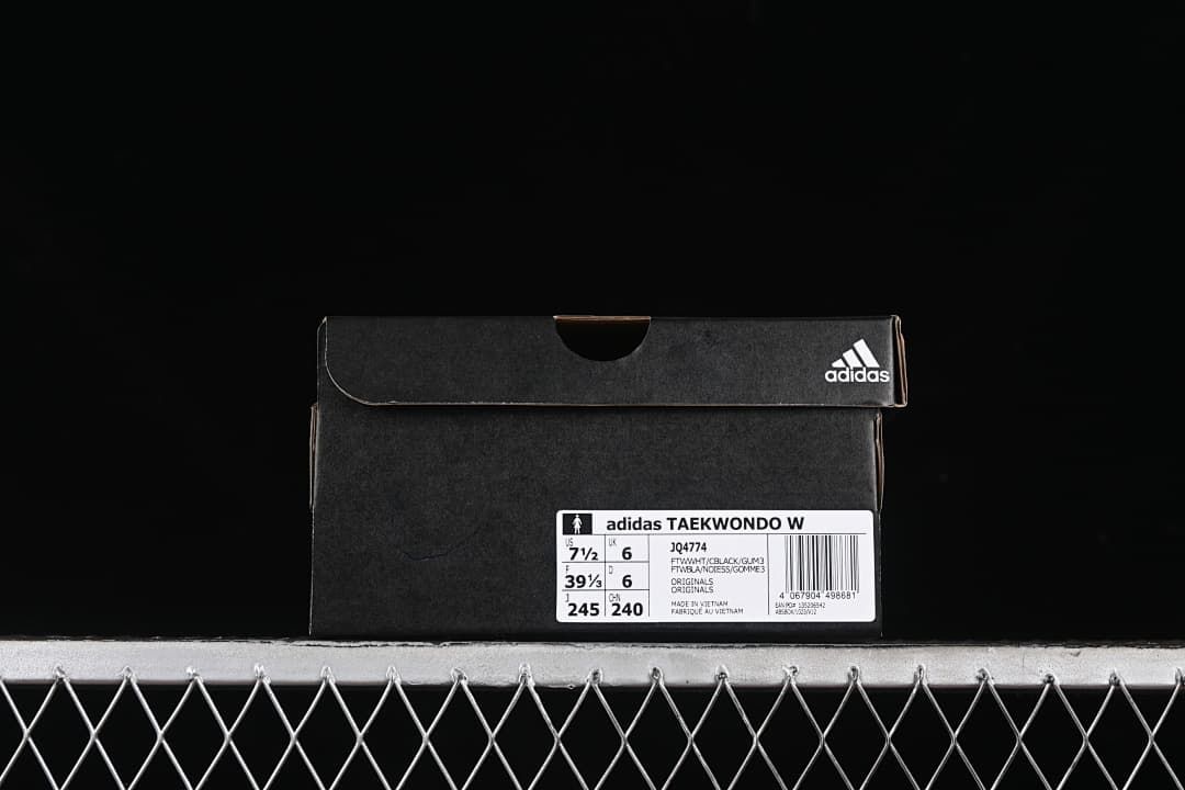 Shoe box label identifying the adidas Taekwondo W, model JQ4774, and sample size markings.