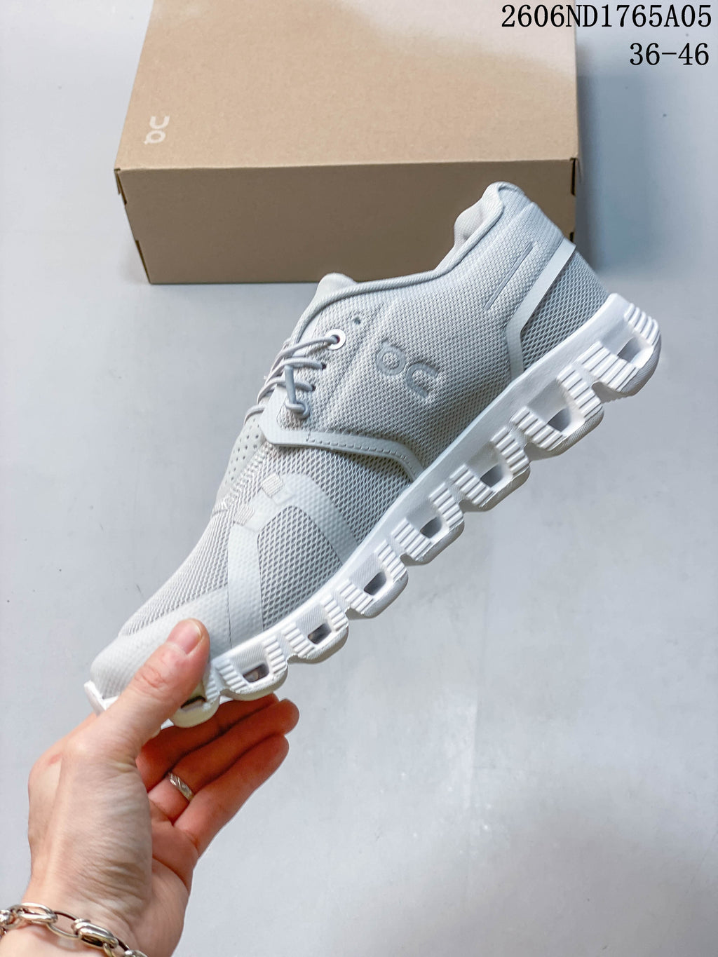 Side view showing the mesh-look upper and segmented outsole of an On Cloud 5 sneaker