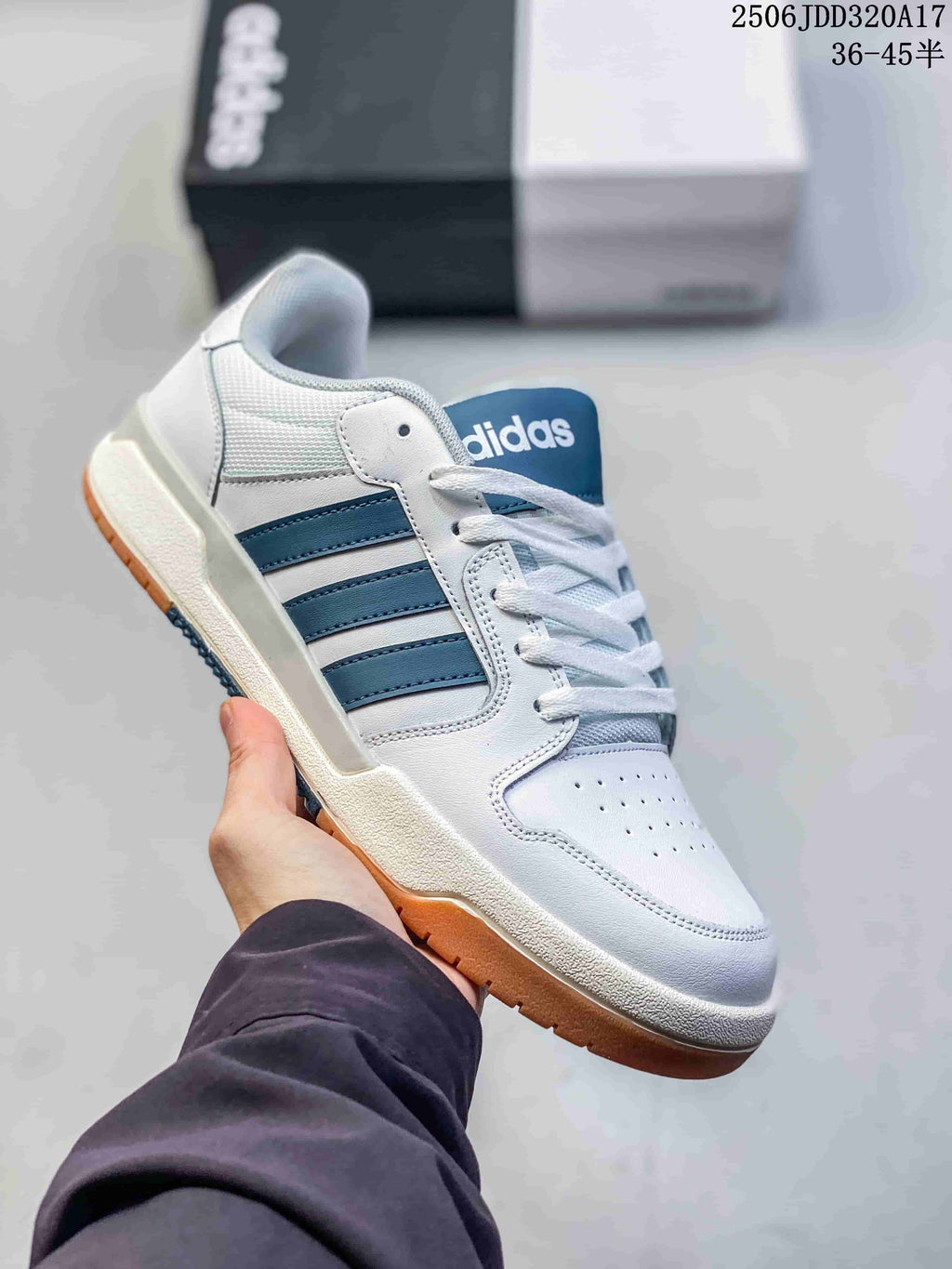 White adidas Entrap low-top sneaker with blue side stripes and a gum-colored outsole