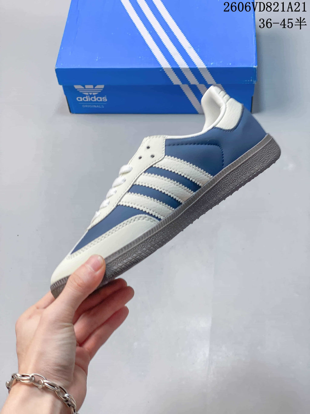 Side profile of the blue and white low-top sneakers with three stripes