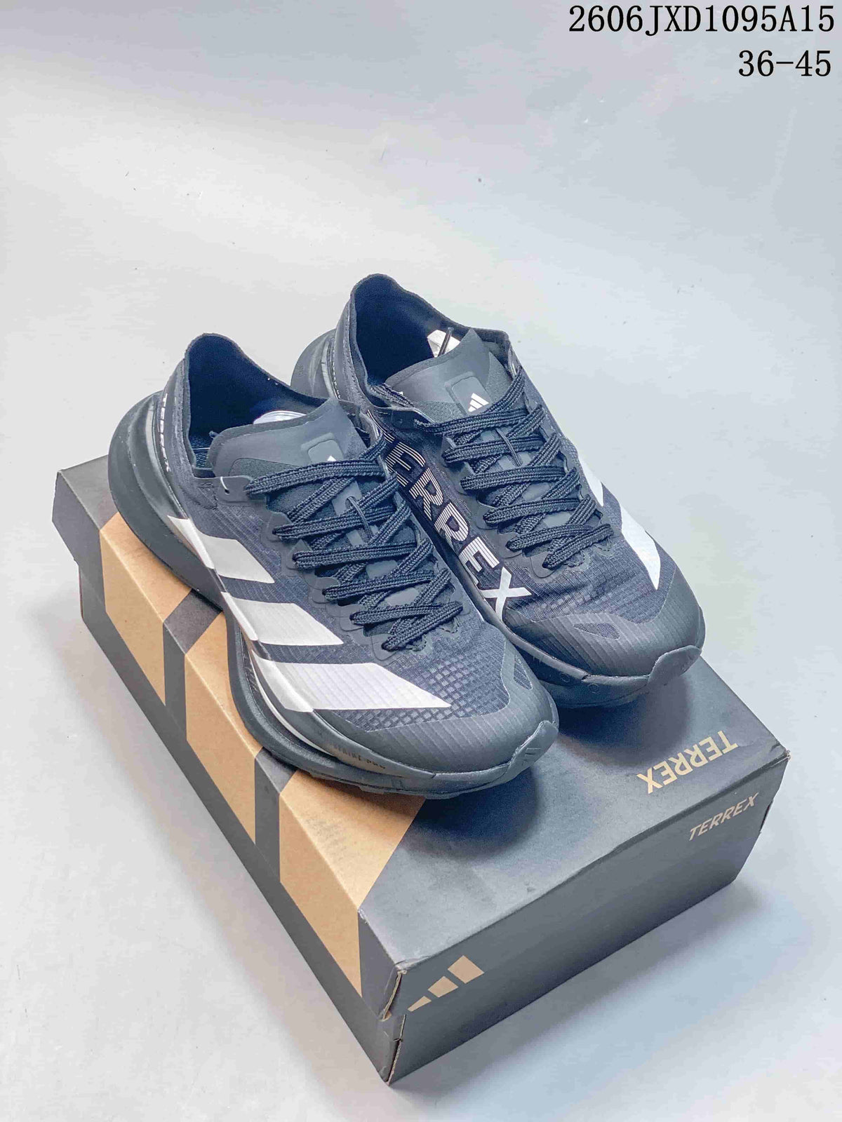 Charcoal Adidas Terrex shoes with white stripes on a branded box
