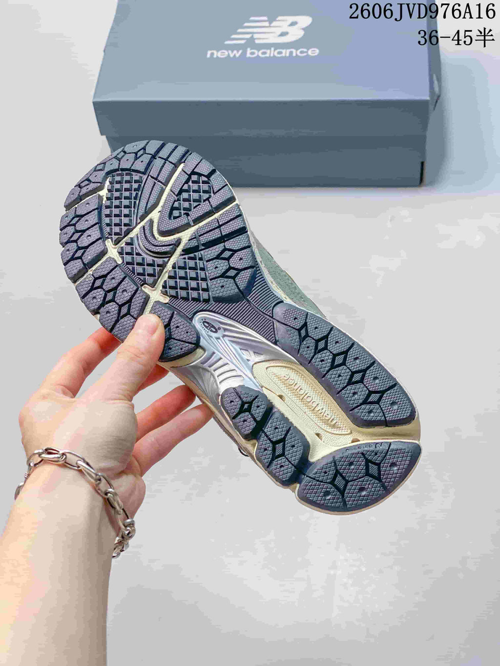 Close-up of the patterned outsole on a grey sneaker.