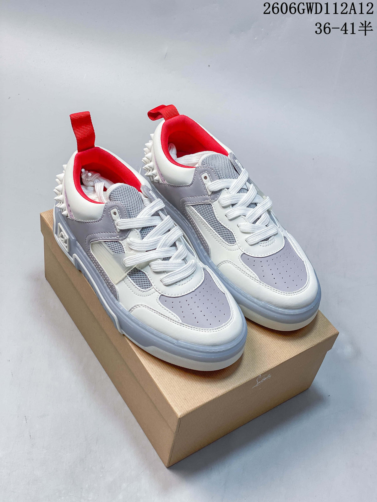 Pair of white and grey low-top sneakers with red lining and studded heel details