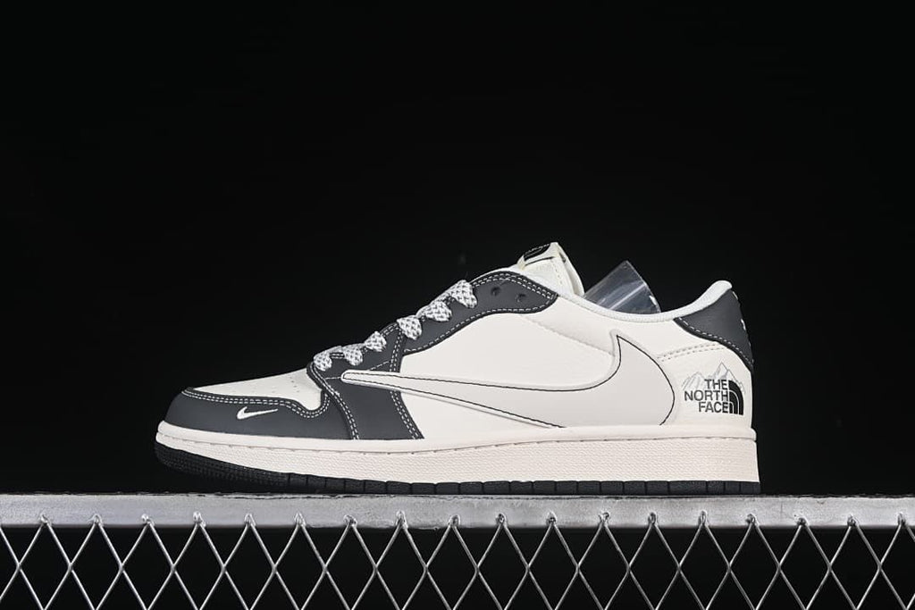 Side view of an off-white and dark gray low-top sneaker with a large Swoosh and co-branded heel detail.