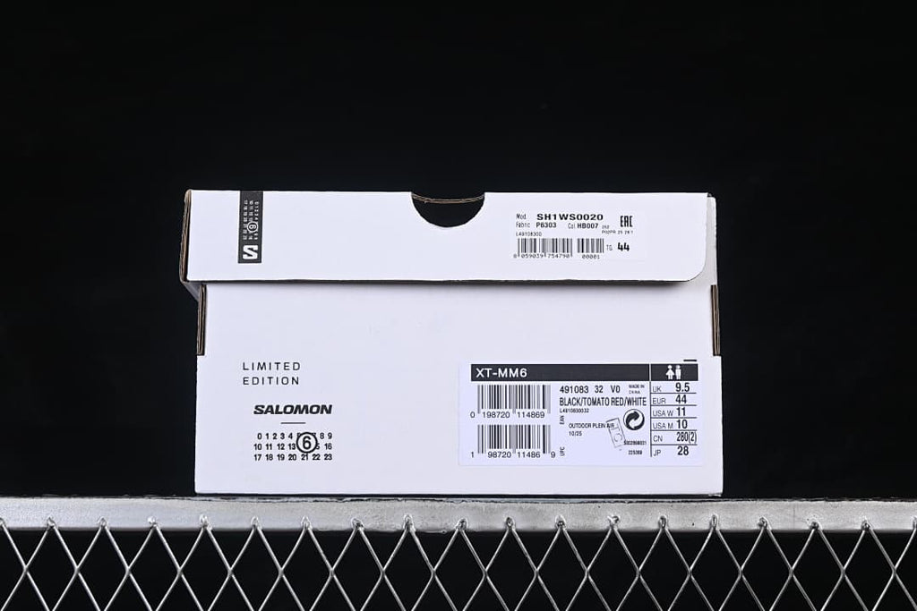 Shoe box label identifying XT-MM6, article 491083, and Black/Tomato Red/White; the label shows EU 44