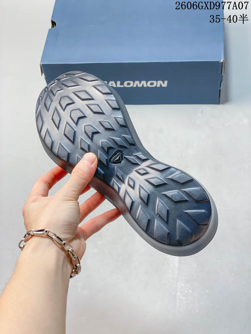 Close-up of the patterned tread on the gray sneaker outsole.