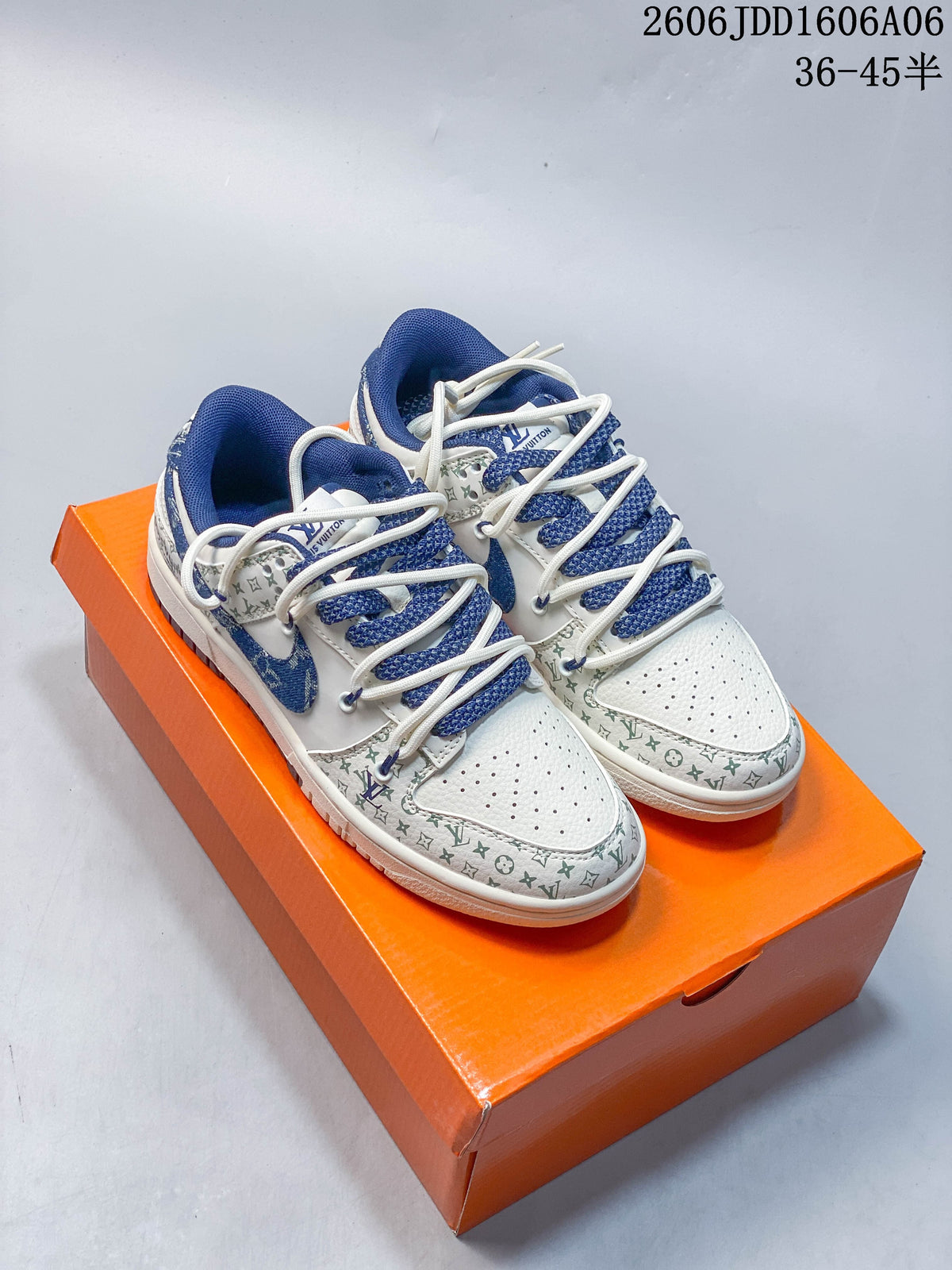 White and blue patterned Nike SB Dunk Low sneakers displayed on an orange box
