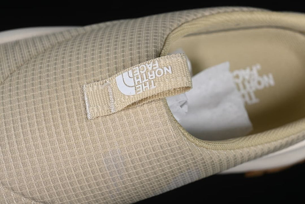 Close-up of the upper and branded pull tab.