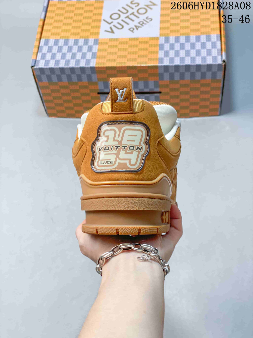 Rear view of the brown sneaker showing heel details and padded collar