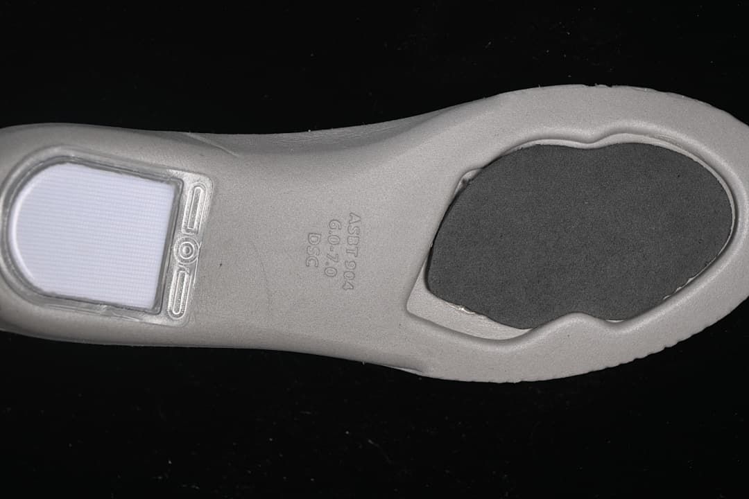 Underside of the shoe's insole showing molded markings