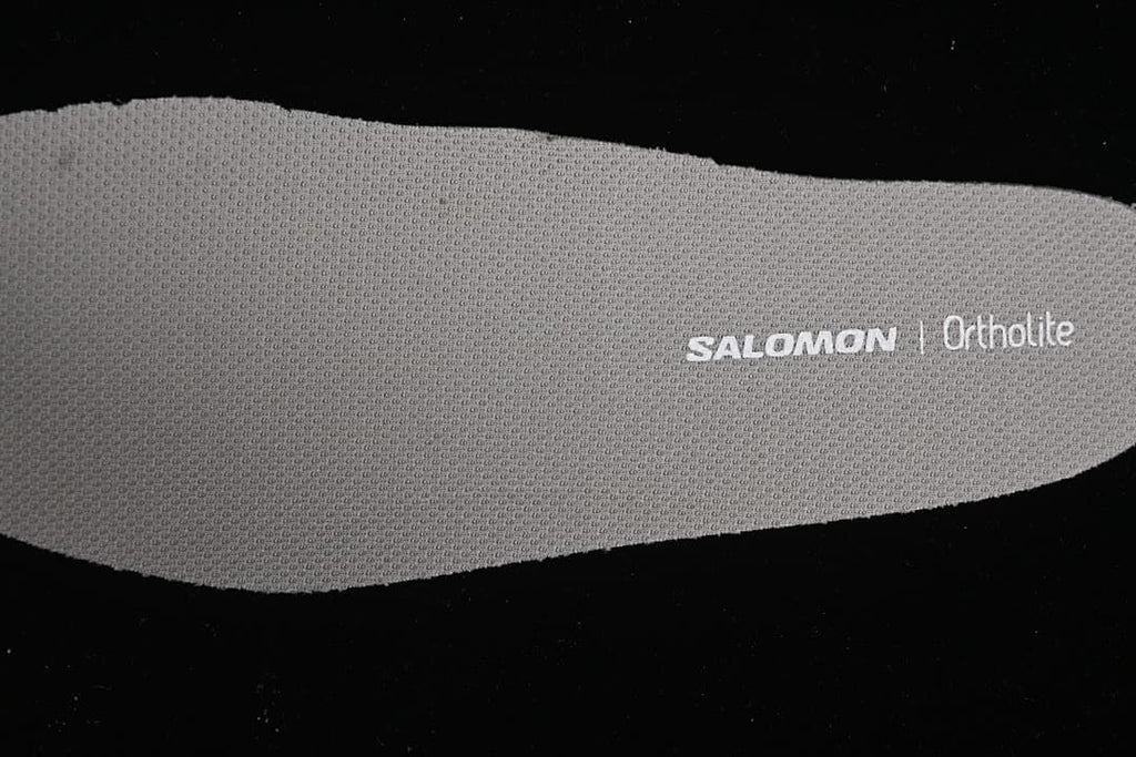 Close-up of a textured insole with Salomon and Ortholite markings.