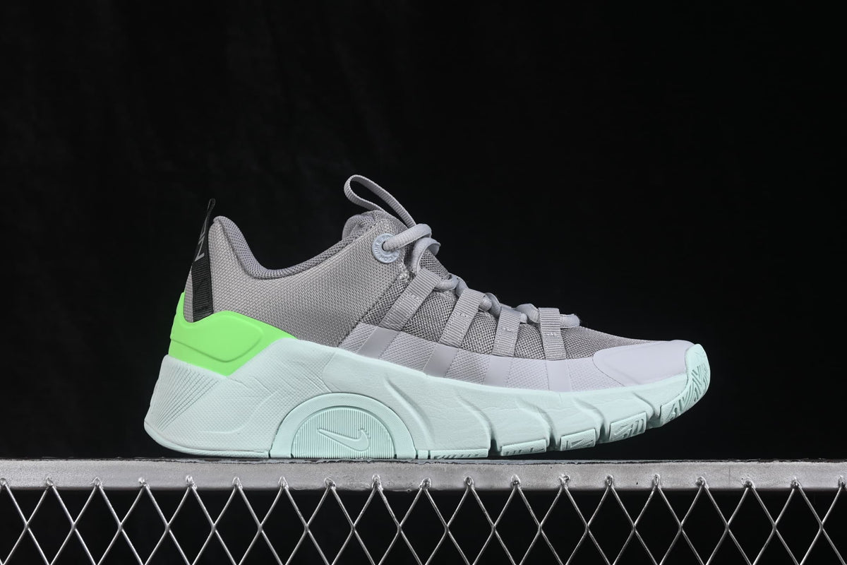 Side view of gray Nike Free Metcon 7 sneakers with white and bright green details and a pale green outsole.