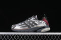 Side view of charcoal and silver-gray adidas Adistar Cushion sneakers with burgundy heel accents.
