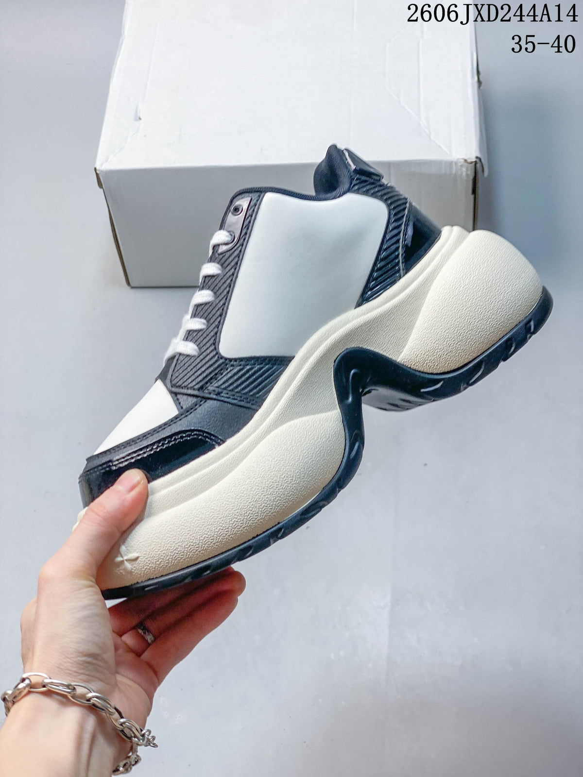 Side view of a white and navy SMFK sneaker with a chunky cream-colored sole