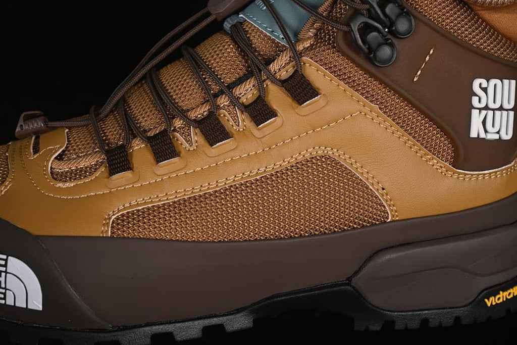 Close-up of brown mesh side panel, overlays and lacing