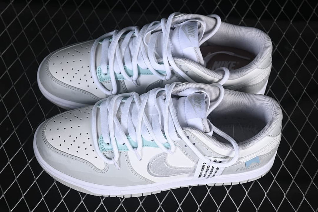Pair of white and grey low-top sneakers shown from above